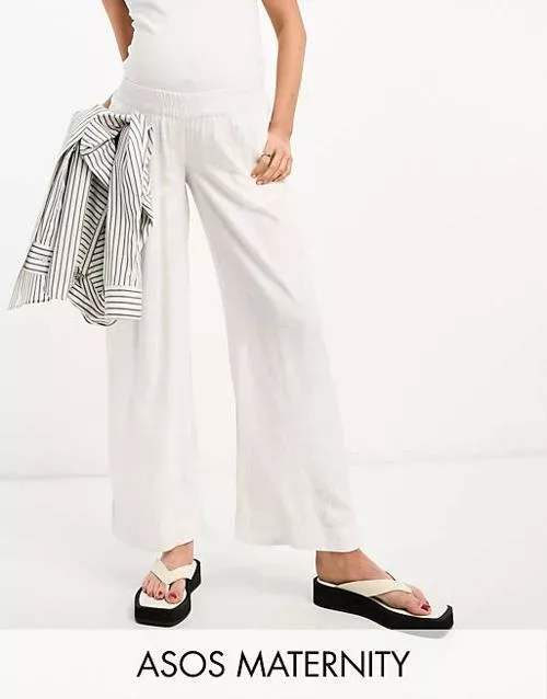 Woman in white maternity linen pants