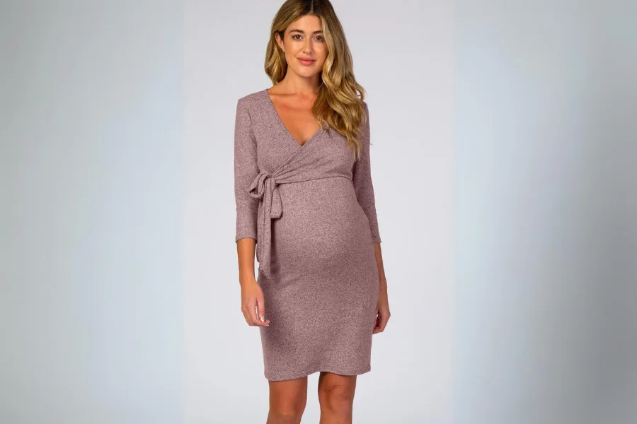 A pinkblush wrap dress worn by a blonde pregnant woman